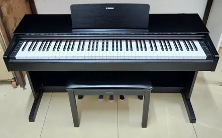The Yamaha YDP-143B is an 88-key console digital piano (finished in Black Walnut) designed