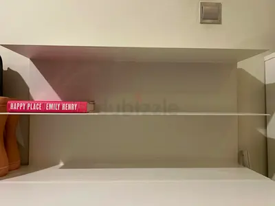 White wall-mounted shelving unit — simple, light-use condition