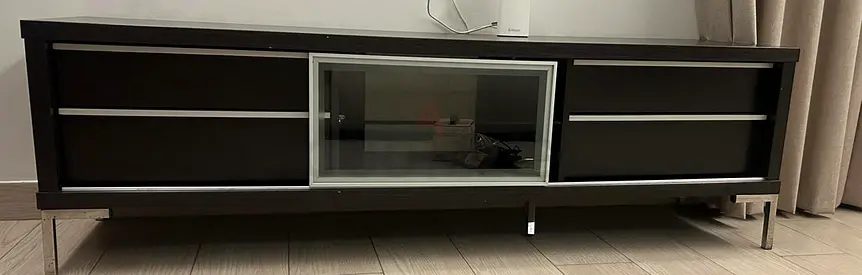 Low modern TV entertainment unit with glass door - dark wood finish