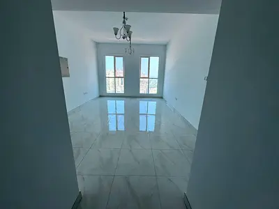 Two rooms and a living area with built-in wardrobes, located on the first row along the Ajman Corniche.