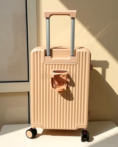 Small blush pink hard-shell carry-on suitcase with spinner wheels