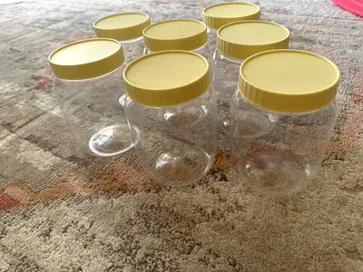Set of 7 Clear Plastic Storage Jars with Yellow Lids - Good Condition