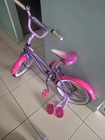 Child's pink & purple 16-inch bike with training wheels — good condition