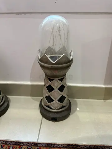 Pair of decorative metal lanterns with glass domes