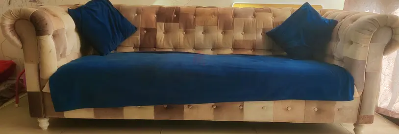 Beige Tufted 3-Seater Sofa with Blue Throw and Cushions