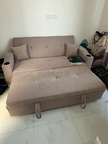 Light grey 2-seater sofa bed with cup holders. Queen size sofa bed