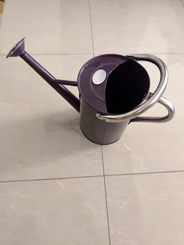 Metal watering can with long spout
