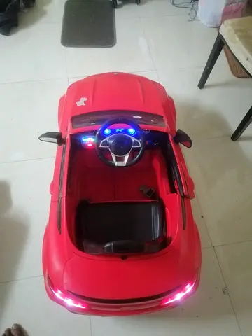 Red Electric Ride-On Toy Car for Kids with Working Lights and Steering Wheel. Good working condition