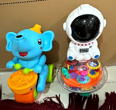 Pair of kids' musical elephant ride-on toy and astronaut gear toy — good condition