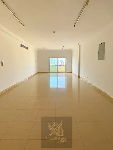 Spacious 3-bedroom apartment for rent in Abu Shagara, Sharjah, featuring a large living room, 1 master bedroom, a maid’s room, 3 bathrooms, a kitchen,