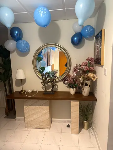 Wooden Console Table with Decorative Accents and Round Mirror