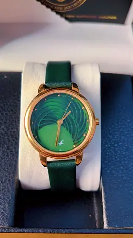 Green dial women's wristwatch with gold case and leather strap