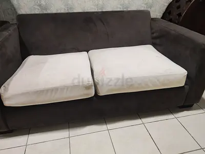 Two-seater grey fabric sofa with removable cushions — good condition