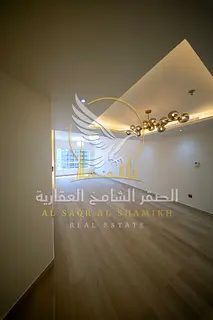 For rent in Al Qasba, Sharjah: a spacious two-bedroom apartment with a living area and modern finish
