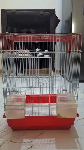 Red plastic base bird cage with twin feeders - good condition