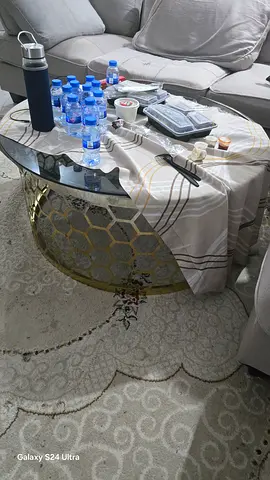Round gold metal and glass coffee table