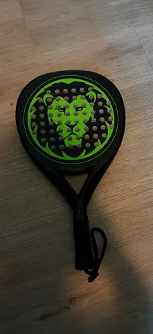 Used green-black padel racket with wrist strap