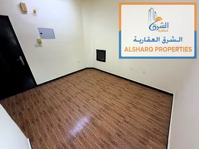 Studio for annual rent in Al Rashidiya 1, next to Nesto Hypermarket. Features an excellent view, a semi-separate kitchen, and central air conditioning