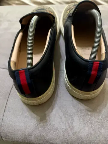 GUCCI Black leather slip-on sneakers with red-blue heel tab, pre-owned