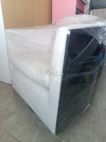 Modern single-seater armchair in white and black - wrapped for pickup