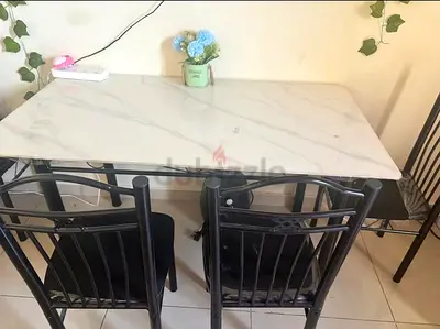 Compact marble-top dining table with 4 chairs - good condition
