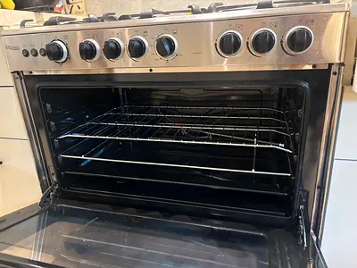 Less than one year old. Stainless steel gas freestanding cooker with oven and 6 burners - perfect.
