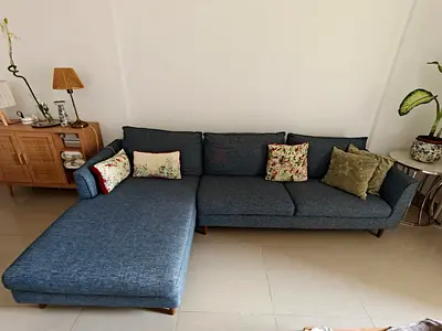 Blue fabric L-shaped sofa with chaise, good condition