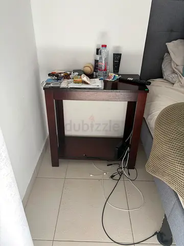 Solid wood bedside/side table in dark brown — good condition