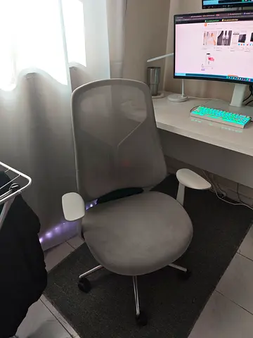 Comfortable grey mesh office chair with armrests and wheels