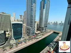 Three bedrooms and a living room for annual rent with a view of Al Qasba and Al Majaz Lake + parking