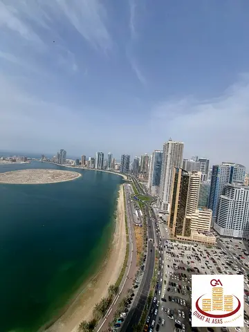 For sale in Al Waha Residential Tower: one bedroom and a living room, Model 2 + parking and a balcony with a sea view of Al Khan Lake