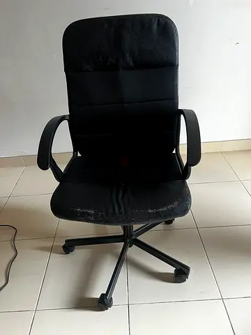 Used black swivel office chair with armrests — fair condition