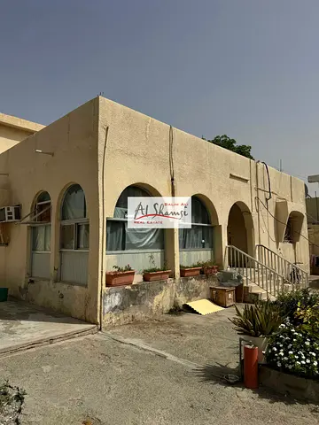 Traditional-style house for sale, located in front of a mosque and a main road; area is 8,000 square feet.