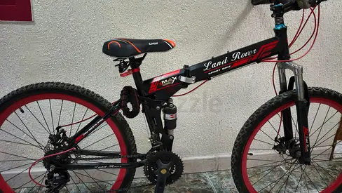 Used mountain bike with front suspension and red rims - good condition