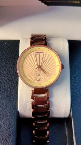 Brown metal women's wristwatch with sunburst dial