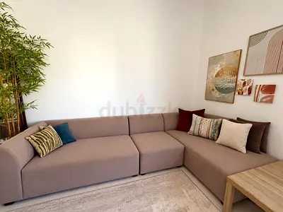 L-shaped modern beige fabric sofa — good condition