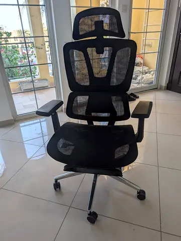Black ergonomic mesh office chair with headrest