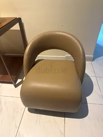 Modern beige upholstered dining/accent chair in good condition for babies