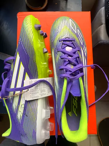 Brand New not Worn size 43 men's football cleats - purple & neon, size visible on tag