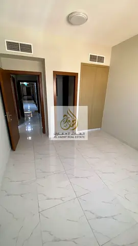 One-bedroom apartment with a separate living room, second-occupancy, 2 bathrooms, and parking; spacious layout, located in Al Rawdah 1.