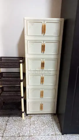 Tall 6-Compartment Plastic Storage Cabinet with Gold Handles and plastic storage rack