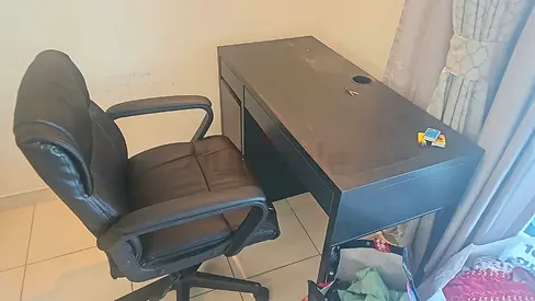 Used black office desk with drawer and ergonomic swivel chair - good condition