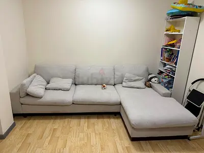 Light grey L-shaped fabric sofa with chaise - good condition