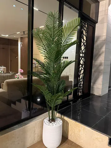 Tall artificial palm plant in white pot -