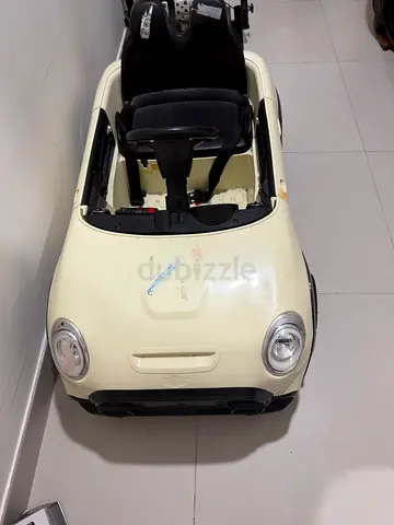Kids electric ride-on car (cream) — single seater, needs minor repair