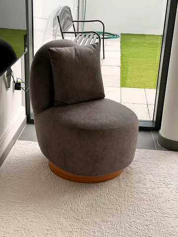 Compact grey swivel accent chair with wooden base - good condition