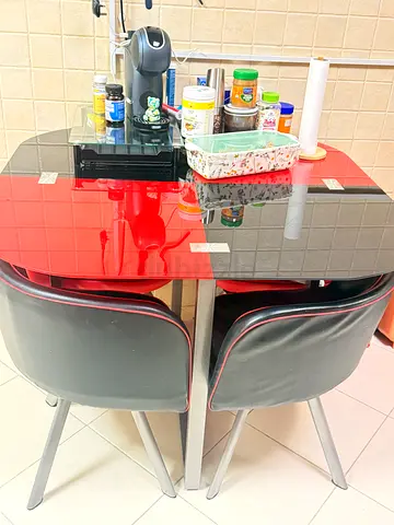Compact red glass-top dining table with 2 stools (good condition)