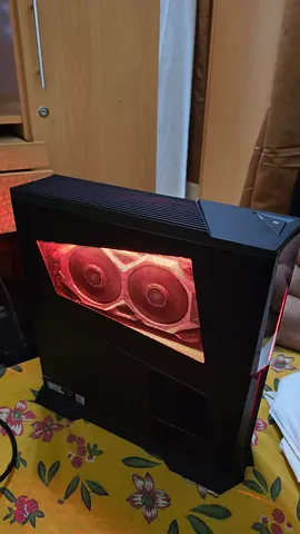 Compact gaming desktop with visible dual GPU fans and RGB lighting