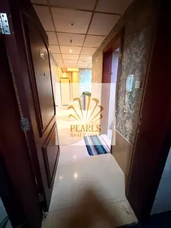 Luxury furnished studio for annual rent in Nuaimiya Tower C, Ajman, with parking in a prime location
