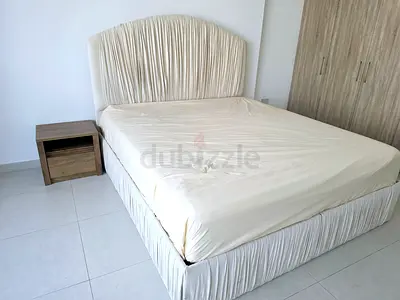 King size bed with upholstered headboard and base, includes bedside table